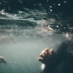 underwater photo of person wearing black shirt