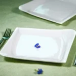 a plate with a butterfly on it next to a fork and knife